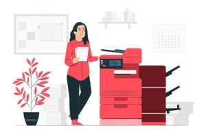 Shopify Order Printer Apps - Woman standing by a photocopier in an office setting with a plant beside her.