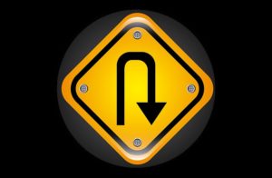 Shopify Redirect Apps - Orange traffic sign with a black background displaying a U-turn arrow symbol